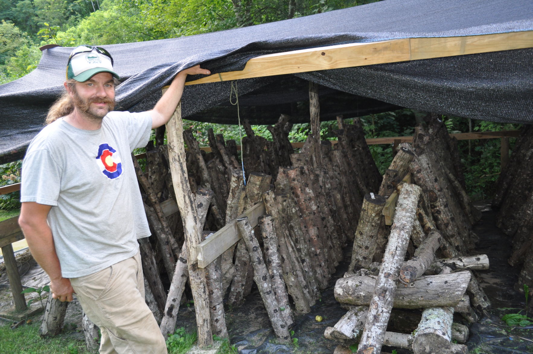 Dustin and mushroom logs.JPG